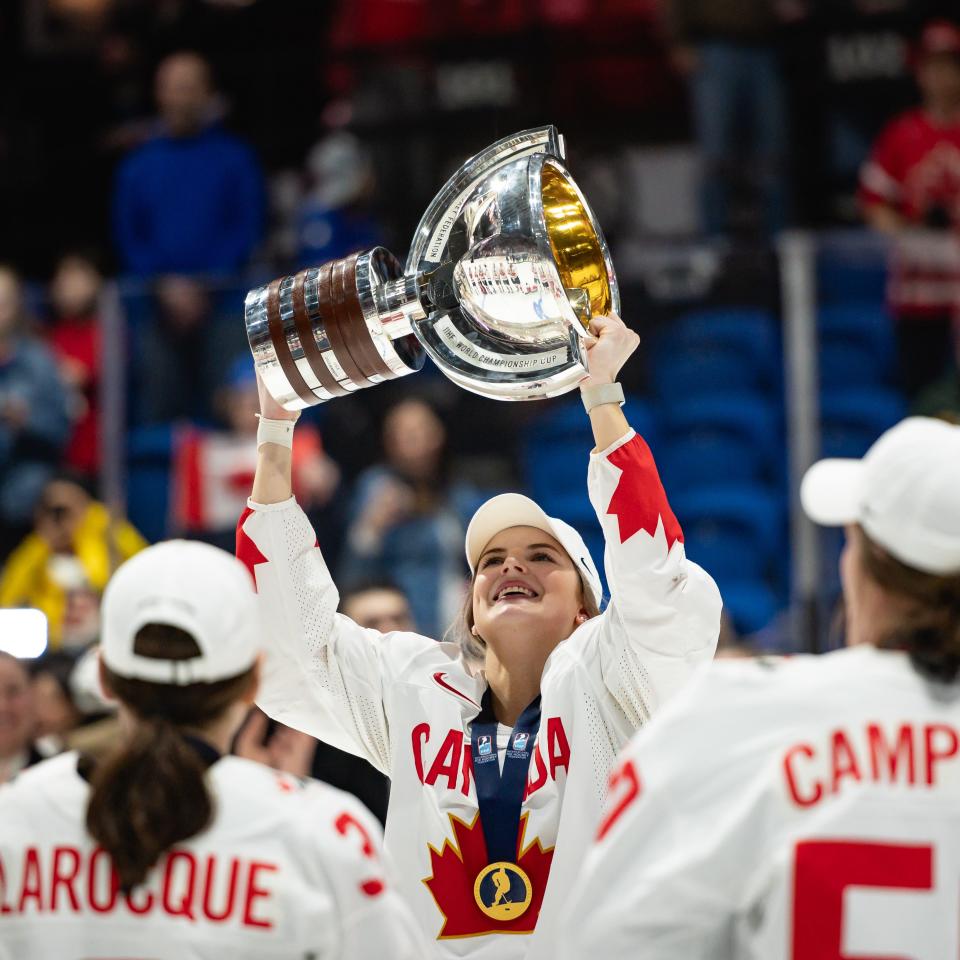Canada's Danielle Serdachny hoists the trophy after her team defeated Team USA in overtime in the IIHC Women's Wold Championship at the Adirondack Bank Center in Utica Sunday. Serdachny, who also plays at Colgate University, scored the winning goal.