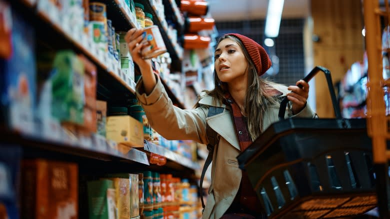 Woman buying canned food