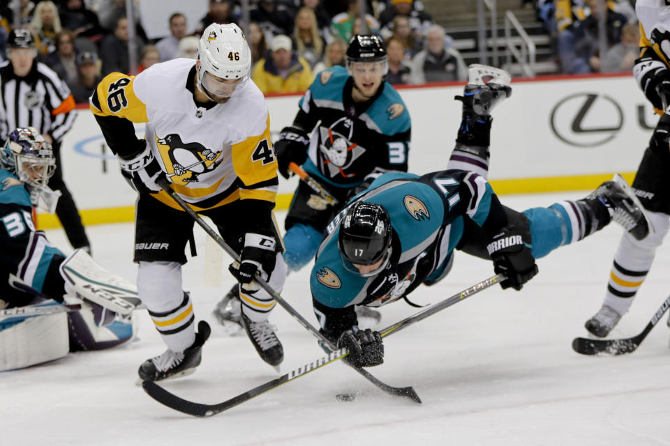 Anaheim Ducks' Ryan Kesler (17) tumbles as he and Pittsburgh Penguins' Zach Aston-Reese (46) battle for the puck during the second period of an NHL hockey game, Monday, Dec. 17, 2018, in Pittsburgh. (AP Photo/Keith Srakocic)