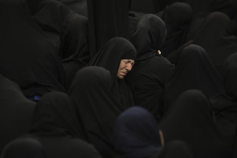 A women weeps during the Ashoura mourning ritual, Friday, July 28, 2023, in Tehran, Iran. Shiite Muslims around the world commemorated Ashoura, a remembrance of the 7th-century martyrdom of the Prophet Muhammad's grandson, Hussein, that gave birth to their faith. (AP Photo/Vahid Salemi)