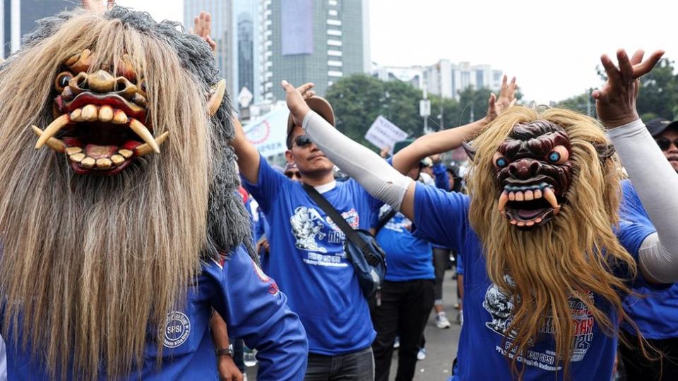 Labourers wear traditional Indonesian Buto masks as they attend a May Day rally in Jakarta.