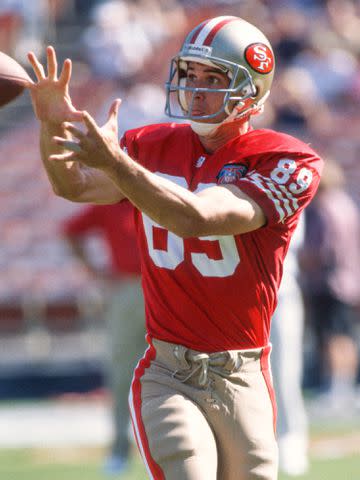 <p>Rick Doyle / Getty</p> Ed McCaffrey playing against the San Diego Chargers in 1994.