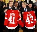 President Bush, right, holds up a jersey with players, Nicklas Lidstrom, from Sweden, left, and Chris Chelios, center, while on stage during a ceremony honoring the 2008 NHL Stanley Cup Hockey Champions the Detroit Red Wings in the East Room of the White House, Tuesday, Oct. 14, 2008 in Washington. (AP Photo/Pablo Martinez Monsivais)