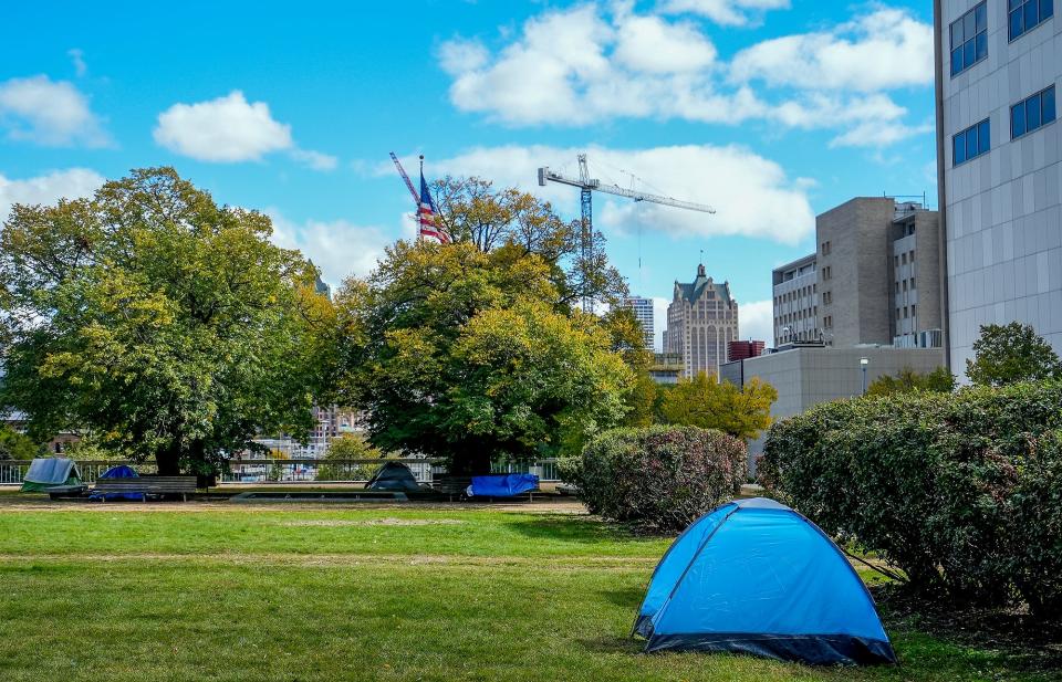 Homeless individuals camp out in tents Friday, Oct. 7, 2022, at MacArthur Square in Milwaukee.