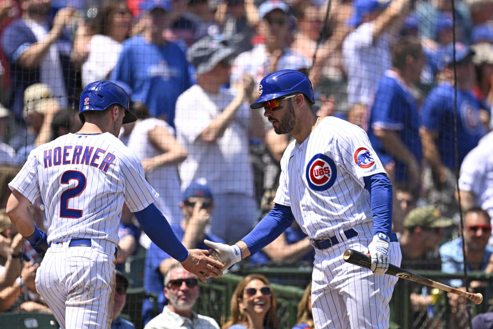 Chicago Cubs' Nico Hoerner (2) is congratulated by Mike Tauchman (40) after scoring during the first inning of a baseball game against the Tampa Bay Rays, Wednesday, May 31, 2023, in Chicago. (AP Photo/Quinn Harris)