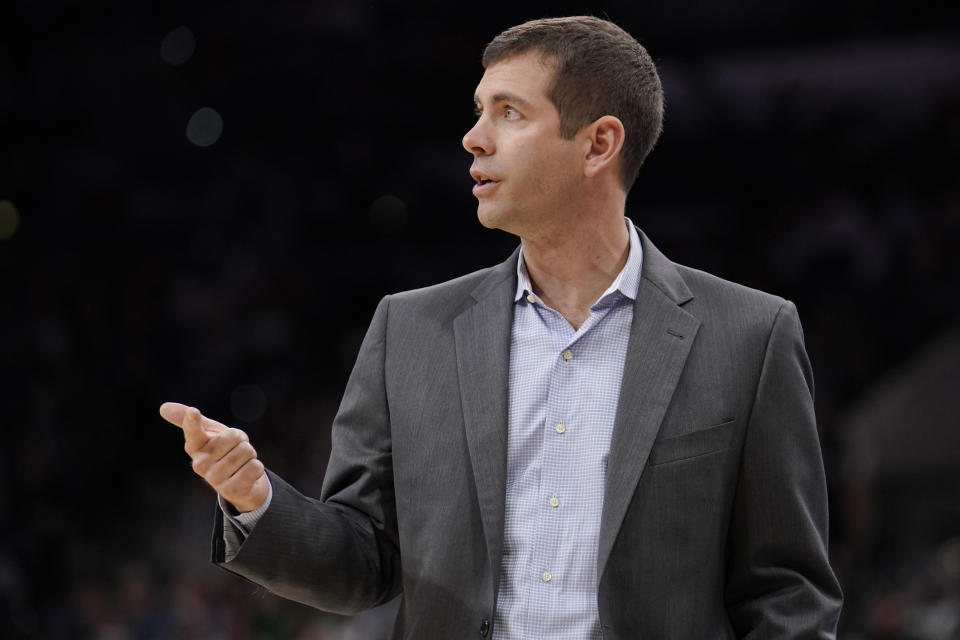 Boston Celtics head coach Brad Stevens signals to his players during the first half of an NBA basketball game against the San Antonio Spurs, Saturday, Nov. 9, 2019, in San Antonio. (AP Photo/Darren Abate)