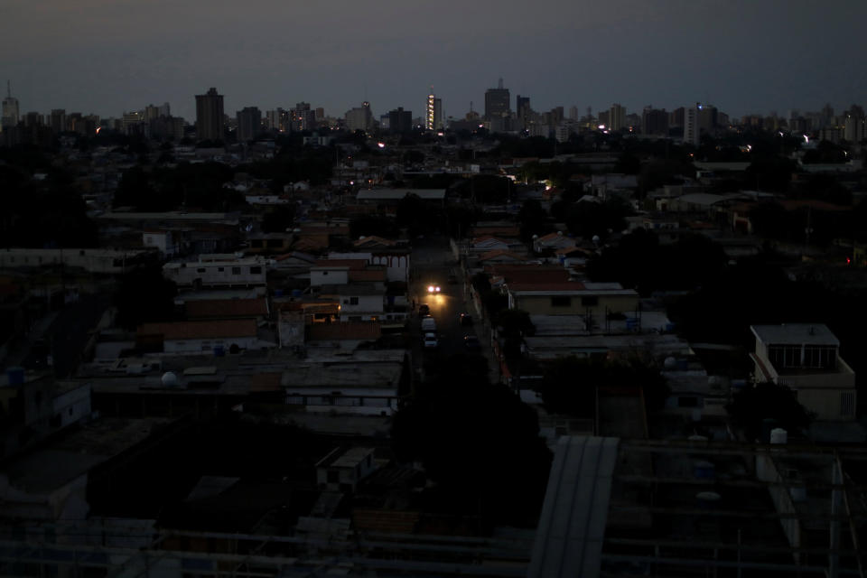 A car's headlights are seen in a neighborhood during a blackout in Maracaibo, Venezuela. (Photo: Ueslei Marcelino/Reuters)