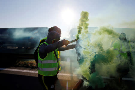 FILE PHOTO: People wearing yellow vests, a symbol of French drivers' nationwide protest against higher fuel prices, block the Paris-Brussels motorway in Haulchin, France, November 17, 2018. REUTERS/Pascal Rossignol