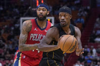 Miami Heat forward Jimmy Butler, right, prepares to pass as he is guarded by New Orleans Pelicans forward Brandon Ingram during the first half of an NBA basketball game Wednesday, Nov. 17, 2021, in Miami. (AP Photo/Wilfredo Lee)