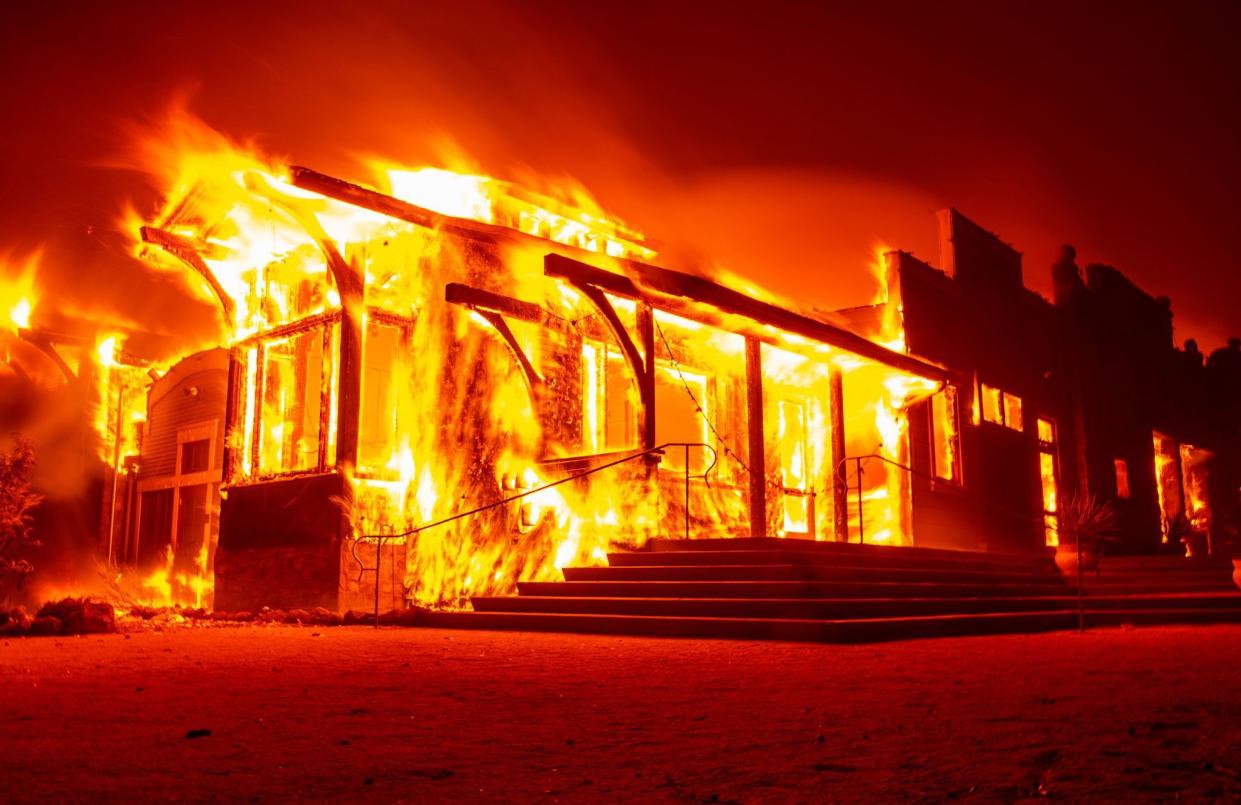 The Soda Rock Winery burns as flames race through Healdsburg, Calif. on Oct. 27, 2019.