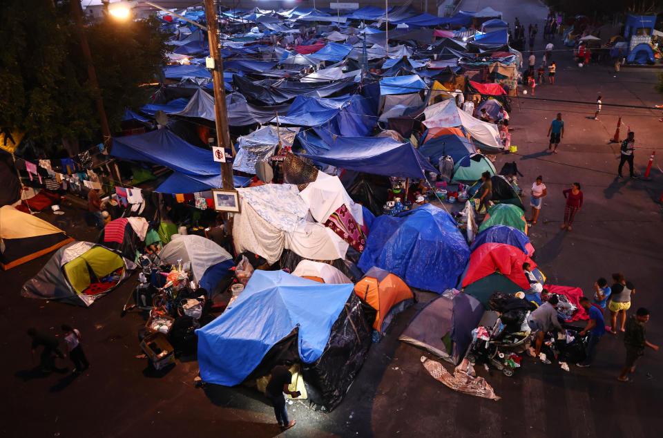 Asylum-seeking migrants gather at a makeshift camp on the Mexican side of the San Ysidro Port of Entry on July 20, 2021, in Tijuana, Mexico. / Credit: Getty Images