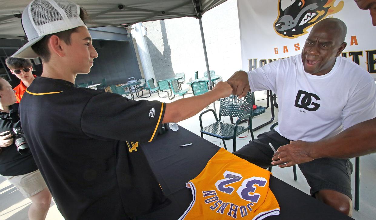 Bryson Peoples, 16, of Gastonia, has a jersey signed by Magic Johnson Friday, Sept. 9, 2022, before the Honey Hunter’s game against the Lexington Legends at CaroMont Health Park.