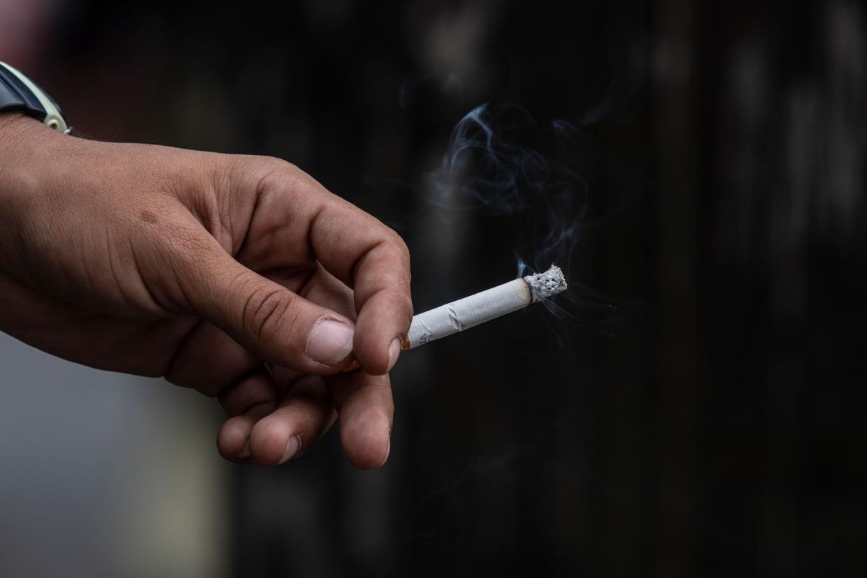 A man smokes a cigarette that was allegedly smuggled into Venezuela (AFP via Getty Images)