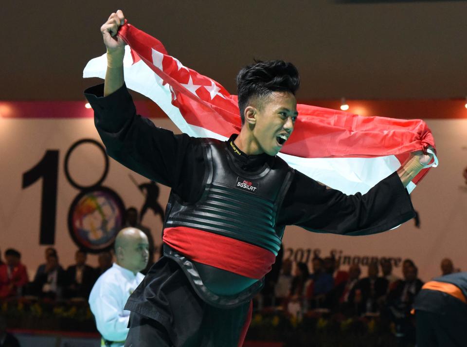 Muhammad Hazim Mohd Yusri celebrates after winning the gold medal in the men’s Class B (50-55kg) division at the World Pencak Silat Championships. (PHOTO: Singapore Silat Federation)