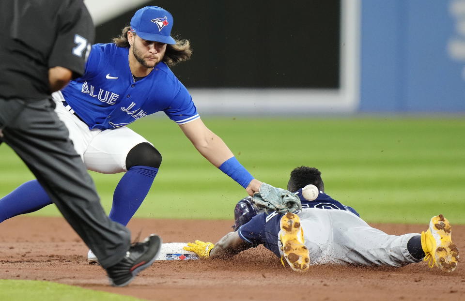 Tampa Bay Rays' Randy Arozarena steals second base ahead of the tag from Toronto Blue Jays shortstop Bo Bichette during the third inning of the second baseball game of a doubleheader Tuesday, Sept. 13, 2022, in Toronto. (Frank Gunn/The Canadian Press via AP)