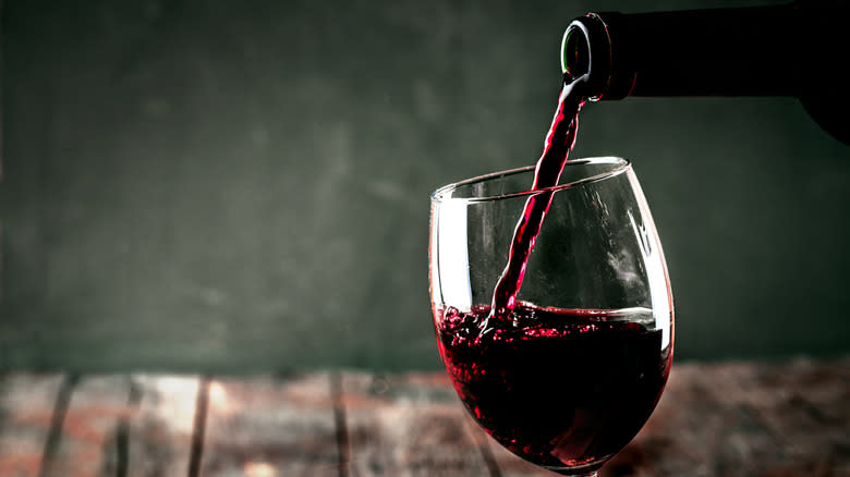 Pouring red wine into glass