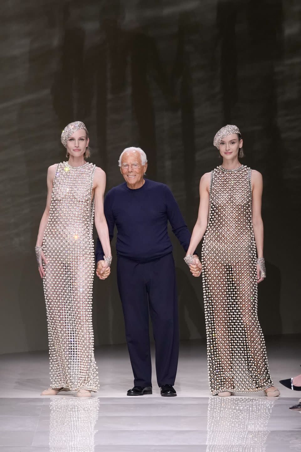 giorgio armani and two women on the runway