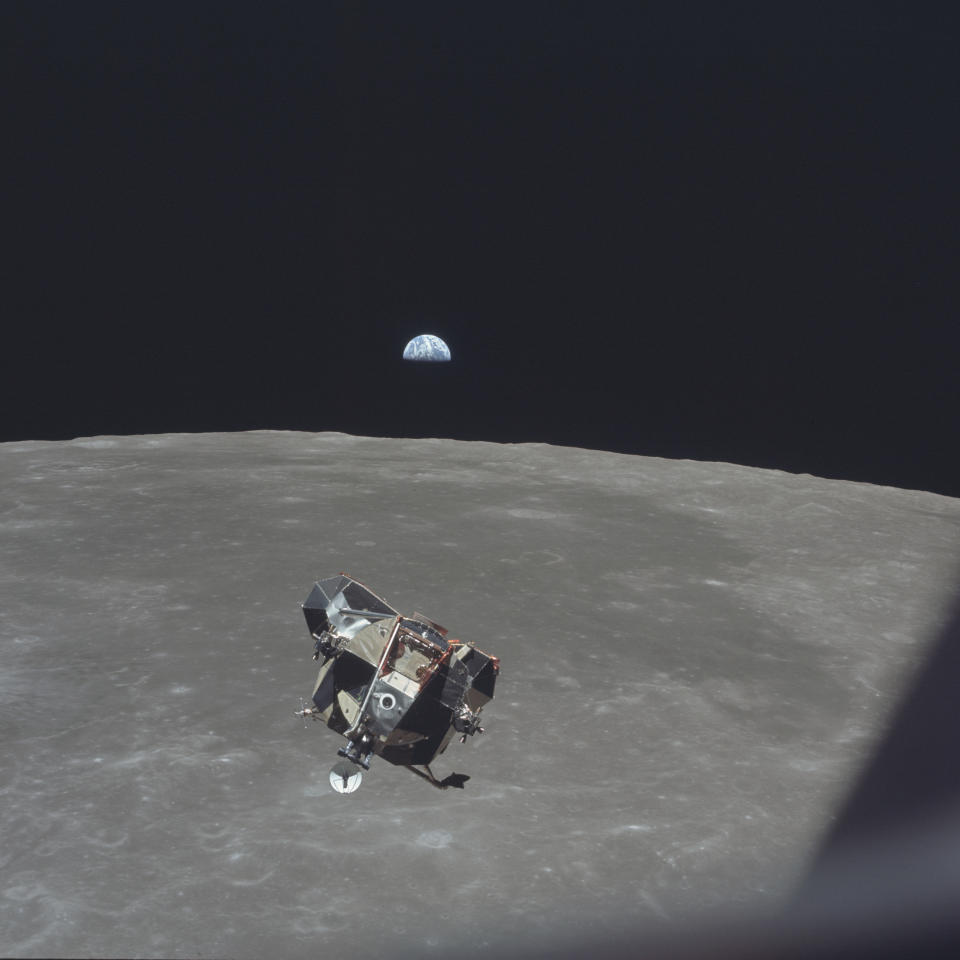 In this July 21, 1969 photo made available by NASA, the Apollo 11 Lunar Module ascent stage, carrying astronauts Neil Armstrong and Buzz Aldrin, approaches the Command and Service Modules for docking in lunar orbit. Astronaut Michael Collins remained with the CSM in lunar orbit while the other two crewmen explored the moon's surface. In the background the Earth rises above the lunar horizon. (Michael Collins/NASA via AP)