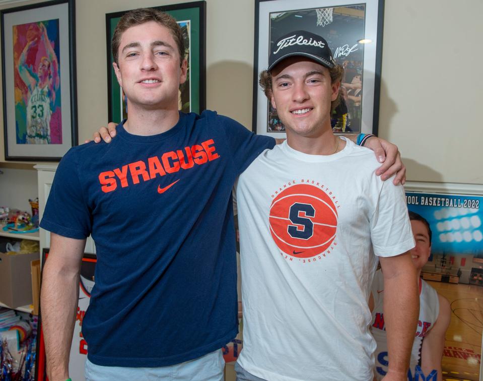 Recent Natick High School graduates Sam and Jack Shuster in their home basement, Aug. 22, 2022.  Both attend Syracuse University.