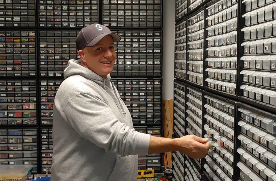 Mike James shows off the expansive library of Lego parts at The Brick Shoppe, which he opened with his wife, Dana, and their children in Kennewick.