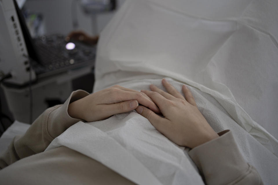 A patient holds her hands while getting an ultrasound at Houston Women's Reproductive Services. (Danielle Villasana for The Washington Post)