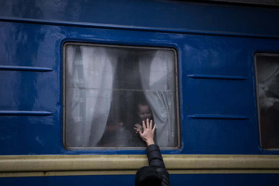 A child waves goodbye to an adult at a train station in Dnipro, Ukraine, on Wednesday. 