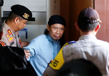 Islamic cleric Aman Abdurrahman leaves a court following his verdict in Jakarta, Indonesia, June 22, 2018. REUTERS/Darren Whiteside