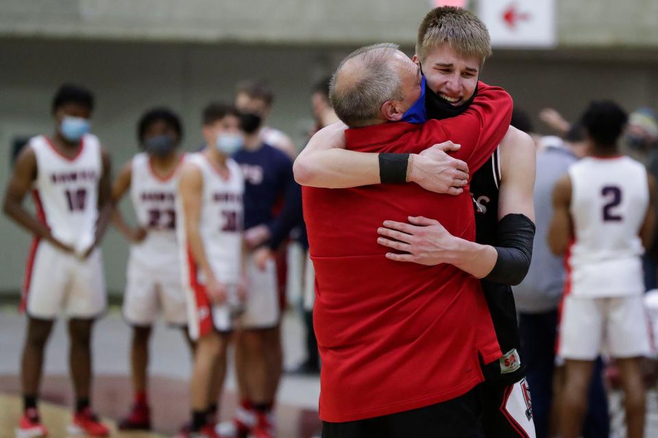Lourdes Academy assistant coach Mac McLaughlin hugs Nathan Slagter after the WIAA Division 4 state championship game on Friday, March 5, 2021, at the La Crosse Center in La Crosse. Lourdes Academy came back from a 27-7 deficit to win, 43-41, on Slagter's game-winning shot at the buzzer.