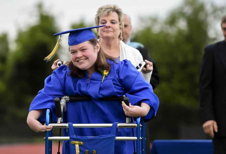 Catie Walsh smiles with her aid, Doris Wagner, a paraprofessional at Tulpehocken High School during commencement ceremony. Walsh, who was diagnosed with cerebral palsy, wanted to leave her wheel chair behind and walk across the field to receive her diploma. Photo by Natalie Kolb 6/7/2017 (Photo By Natalie Kolb/MediaNews Group/Reading Eagle via Getty Images)