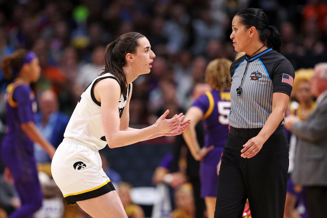 Caitlin Clark speaks to a referee after LSU head coach Kim Mulkey used a coach's appeal on the referees.