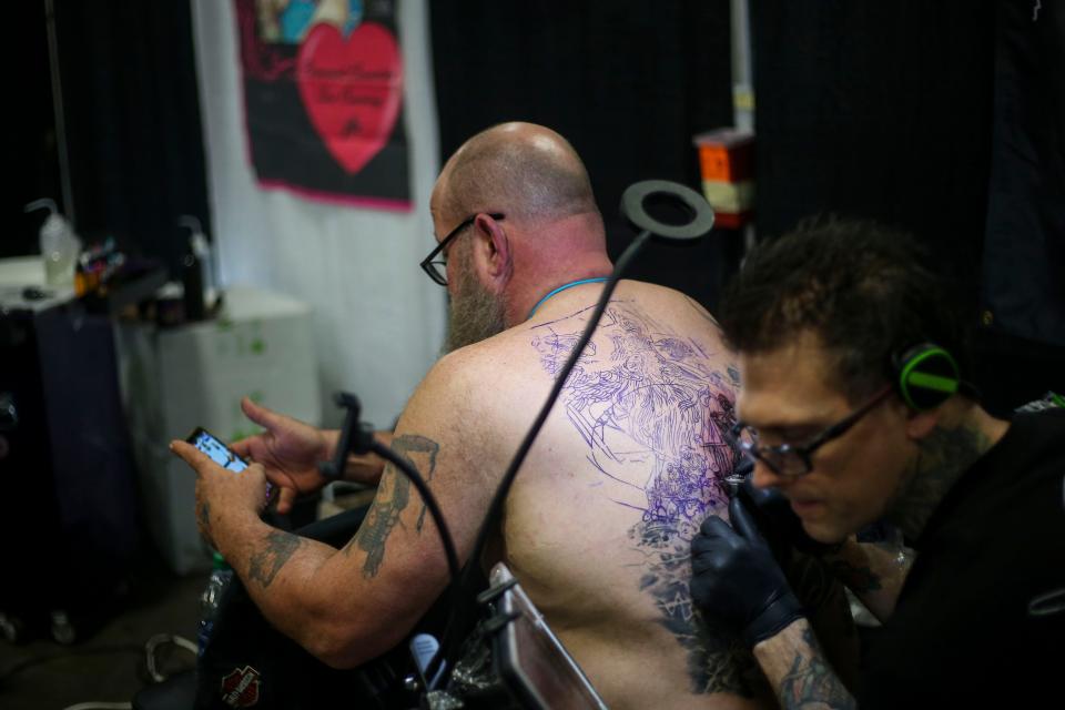 Kyle Dunbar from Ink Masters Seasons 3 and 4 tattoos a back piece he had started earlier in the year on John Schneider, from Cincinnati, during the 8th Annual Louisville Tattoo Arts Convention put on by Villain Arts at the Kentucky Expo Center in Louisville, Ky. on Saturday, April 13, 2019. 