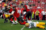 Dec 21, 2014; Tampa, FL, USA; Tampa Bay Buccaneers quarterback Josh McCown (12) throws the ball as Green Bay Packers linebacker Jay Elliott (91) pressures during the second half at Raymond James Stadium. Green Bay Packers defeated the Tampa Bay Buccaneers 20-3. Mandatory Credit: Kim Klement-USA TODAY Sports