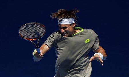 David Ferrer of Spain hits a return to Jeremy Chardy of France during their men's singles match at the Australian Open 2014 tennis tournament in Melbourne January 17, 2014. REUTERS/Jason Reed