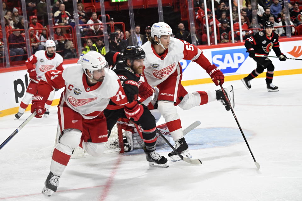 Ottawa Senators Claude Giroux between Detroit Red Wings Dylan Larkin and Moritz Seider during the NHL Global Series Sweden ice hockey match between Detroit Red Wings and Ottawa Senators at Avicii Arena in Stockholm, Sweden, Thursday, Nov. 16, 2023. (Henrik Montgomery/TT News Agency via AP)