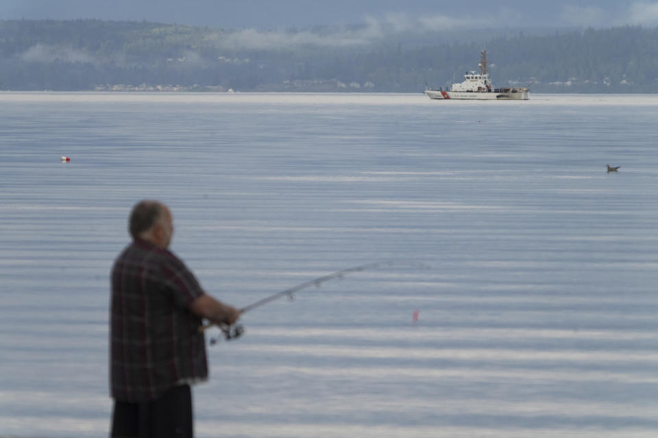 A U.S. Coast Guard vessel searches the area Monday, Sept. 5, 2022, near Freeland, Wash., on Whidbey Island north of Seattle where a chartered floatplane crashed the day before. The plane was carrying 10 people and was en route from Friday Harbor, Wash., to Renton, Wash. (AP Photo/Stephen Brashear)