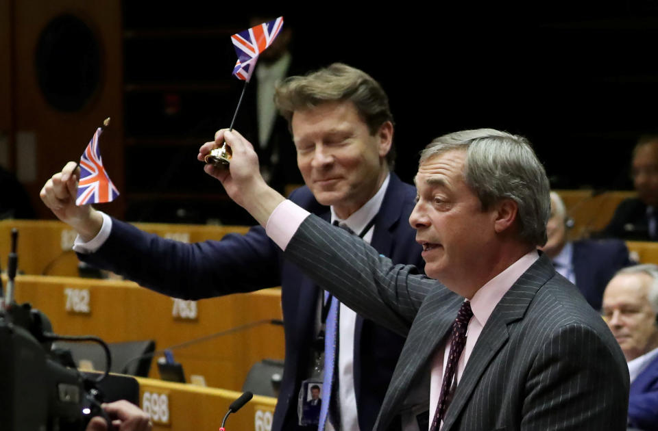 Brexit Party leader Nigel Farage along with other MEPs wave British flags ahead of a vote on the Withdrawal Agreement at the European Parliament in Brussels, Belgium January 29, 2020. REUTERS/Yves Herman