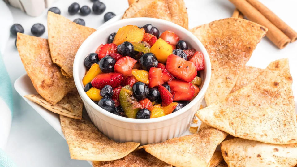 A bowl of fruit salsa with cinnamon chips