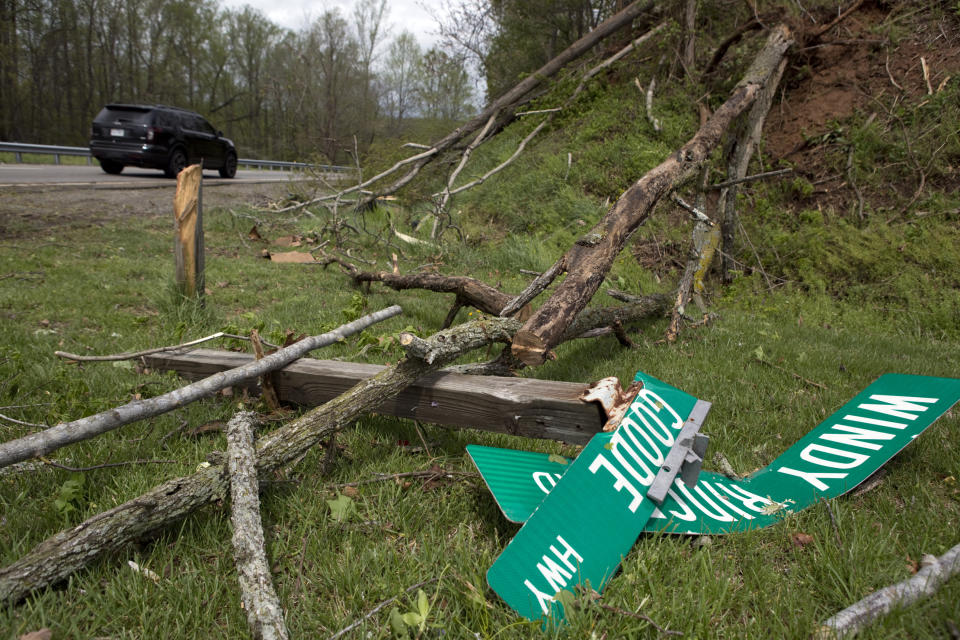 Fallen trees and street signs litter the grass off Highway 220 North after a tornado touched down in Franklin County, Va., Friday, April 19, 2019. (Heather Rousseau/The Roanoke Times via AP)