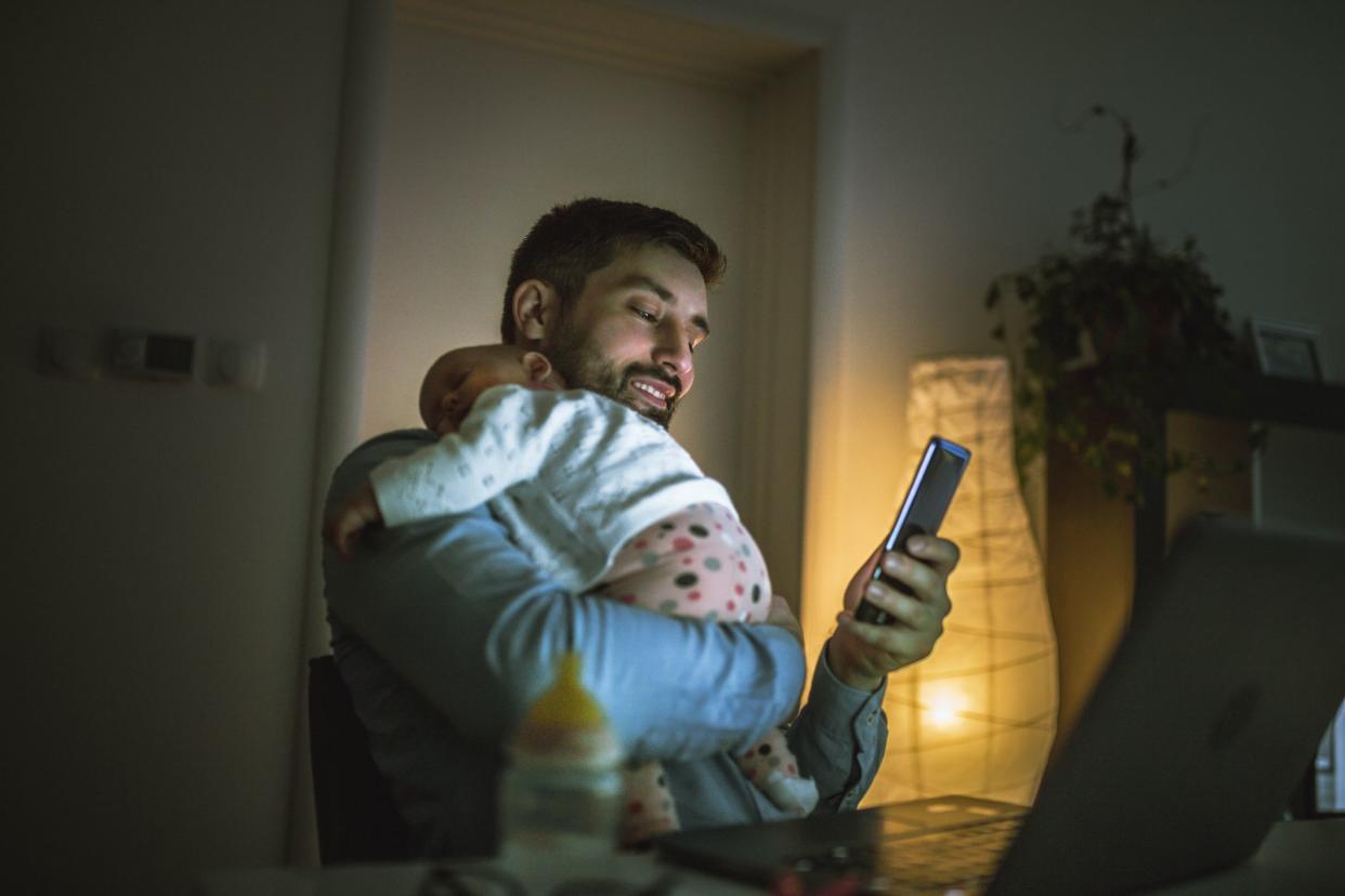 young father working at home with his baby girl