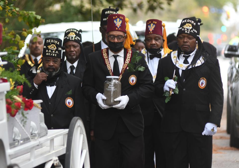 Members of the Knights of Pythias lead the funeral procession for Joshua Halsey at Pine Forest Cemetery in Wilmington in 2021. Halsey was one of many Black people who were killed in Wilmington during the 1898 massacre.