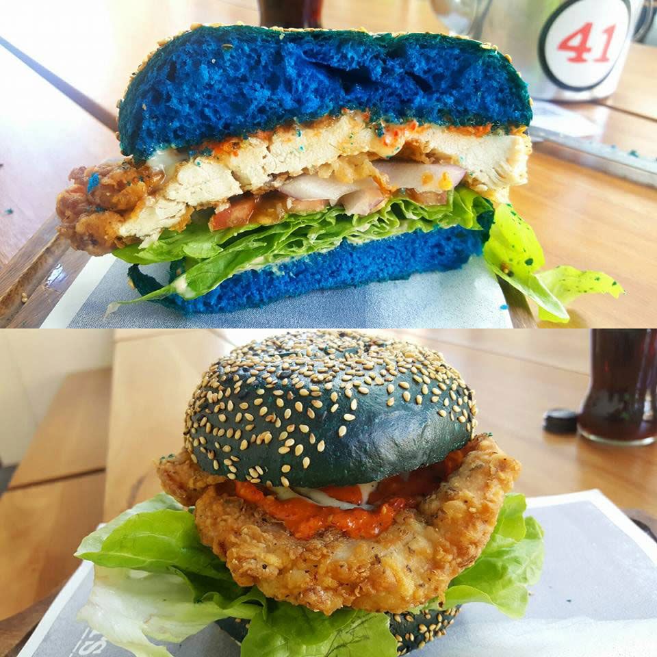 The epic eat consists of triple chilli, fried chicken and blue cheese sandwiched in an electric blue bun. Source: Supplied.