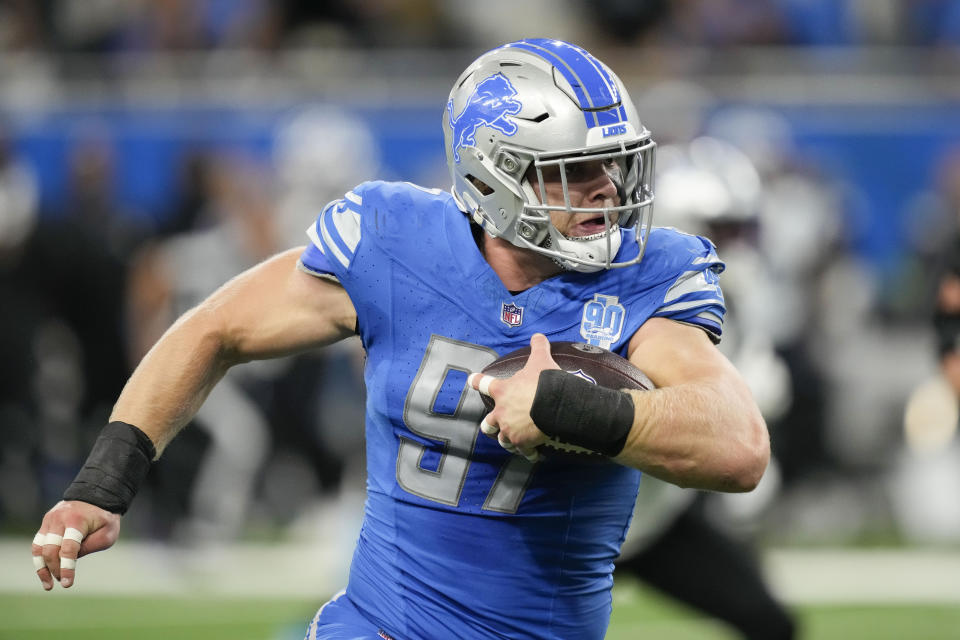 Detroit Lions defensive end Aidan Hutchinson (97) returns an interception in the first half of an NFL football game against the Carolina Panthers in Detroit, Sunday, Oct. 8, 2023. (AP Photo/Carlos Osorio)