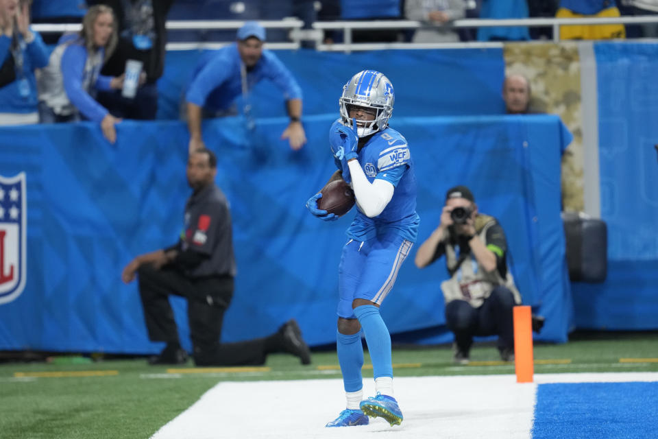 Detroit Lions wide receiver Jameson Williams (9) reacts after his 32-yard pass reception for a touchdown during the second half of an NFL football game against the Chicago Bears, Sunday, Nov. 19, 2023, in Detroit. (AP Photo/Paul Sancya)