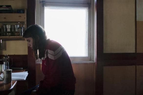 Political activist Yekaterina Samutsevich reads a book as she waits for the birth of fellow Voina member Natalia Sokol's first child Kasper in a secret hideout in Moscow, June 19, 2009. Samutsevich later became a member of Pussy Riot.