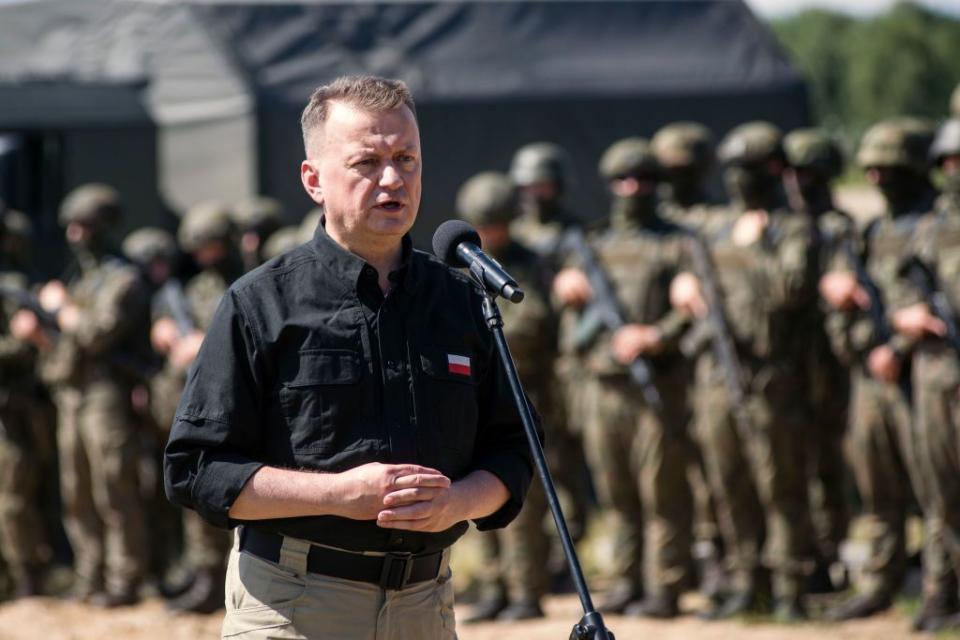 Polish Defense Minister Mariusz Blaszczak speaks at a press conference at a military camp in Jarylowka, near Poland's border with Belarus. (Photo by Attila Husejnow/SOPA Images/LightRocket via Getty Images)