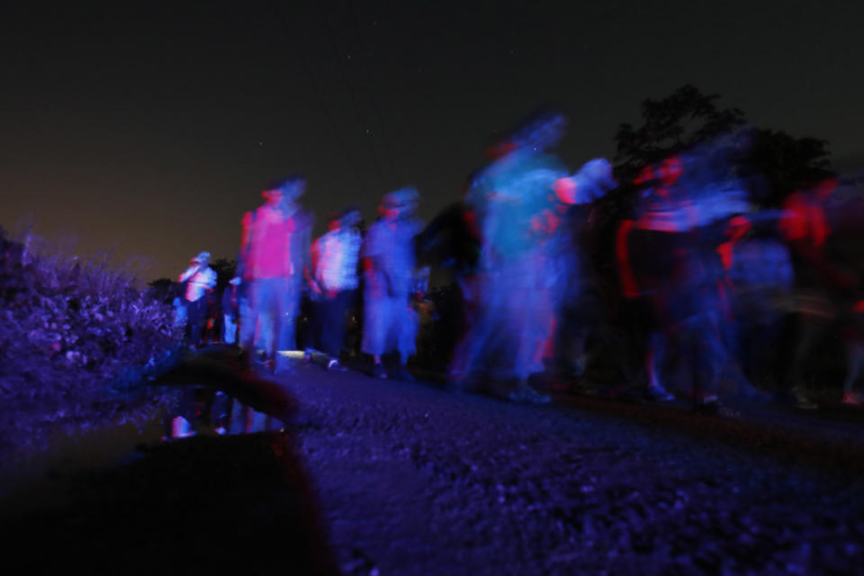 Central American migrants traveling with a caravan to the U.S. make their way to Mapastepec, Mexico, Wednesday, Oct. 24, 2018. After a day of rest to honor a fellow traveler who died on the road on Monday, the march continues through Mexico. (AP Photo/Moises Castillo)