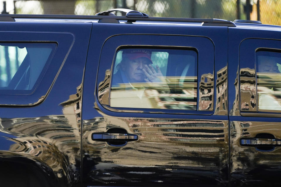 President Donald Trump waves to supporters from his motorcade as people gather for a march Saturday, Nov. 14, 2020, in Washington. (AP Photo/Julio Cortez)