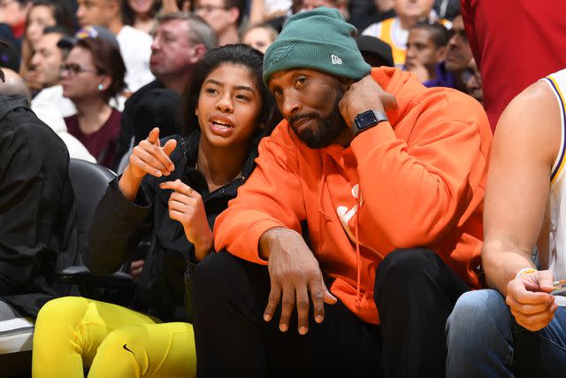 <p>Andrew D. Bernstein/NBAE via Getty</p> Kobe Bryant and Gianna Bryant attend the game between the Los Angeles Lakers and the Dallas Mavericks on December 29, 2019