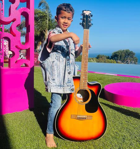 <p>Chrissy Teigen/Instagram</p> The couple's son Miles, 4, played guitar by the pool