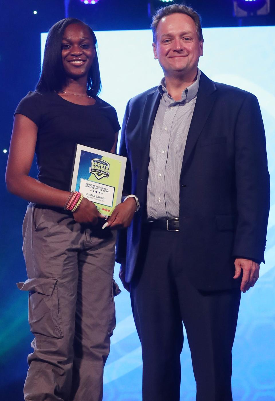 Buchtel High's DaMya Barker Greater Akron Girls Track and Field Player of the Year with Michael Shearer Akron Beacon Journal editor at the High School Sports All-Star Awards at the Civic Theatre in Akron on Friday.